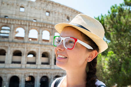 Woman Tourist Wearing Italian Flag Sunglasses In Front Of Colosseum, Rome, Italyの写真素材
