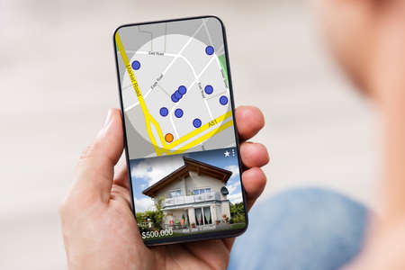 Man Searching For Real Estate Online On Mobile Phone