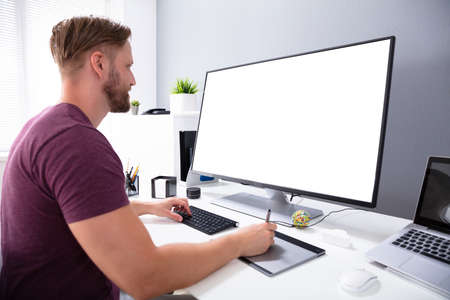Photo Of Designer Working On Computer In Office
