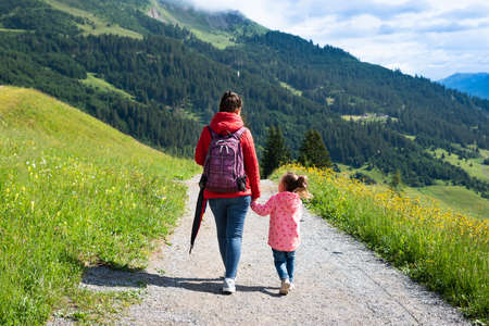 Mother And Little Girl Walking Hiking Trail In Mountainsの写真素材