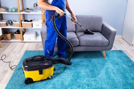 Photo Of Person Cleaning Sofa With Vacuum Cleanerの写真素材