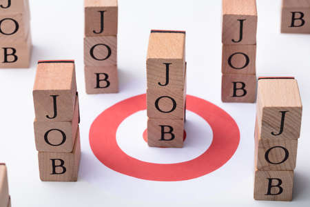 Job Wooden Blocks And Red Darts Target On Deskの写真素材