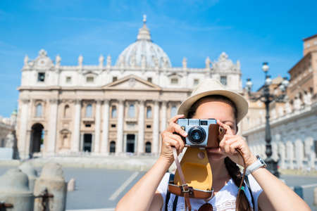 Woman Taking Photos Of St. Peter's Basilica in the Vaticanの写真素材