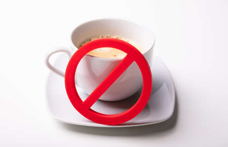 An Overhead View Of Red No Sign On Coffee Cup Over White Backgroundの写真素材