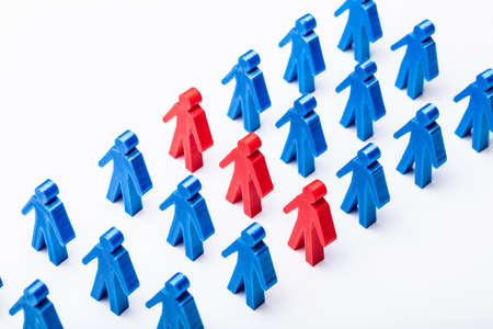 Elevated View Of Red Figures Stand With Blue Figures Group In A Rowの写真素材