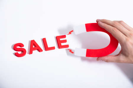 Businessperson Attracting More Sales With Horseshoe Magnetの写真素材
