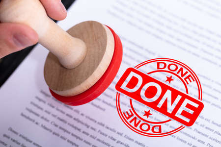 Businessman Hand Putting Done Stamp On Documentの写真素材