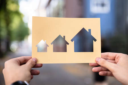 Hands Holding Paper With Cutout House Growth Outdoorsの写真素材