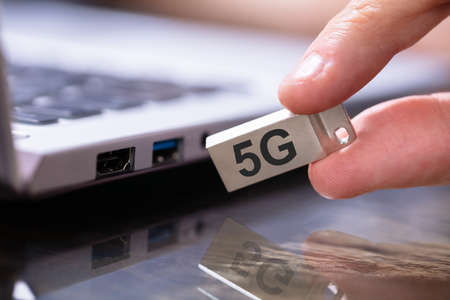 Man Connecting 5G Modem To Laptop Computer