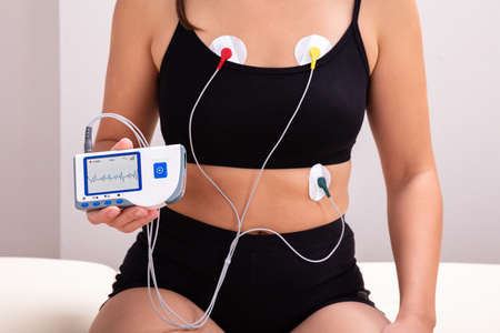 Woman Wearing Holter Monitor Device For Daily Monitoring Of An Electrocardiogramの写真素材