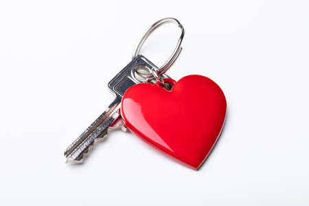 High Angle View Of Key With Red Heart Shape Key Chain Over White Background