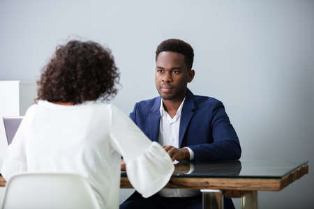 Young Businesspeople Sitting At Interview In Officeの写真素材