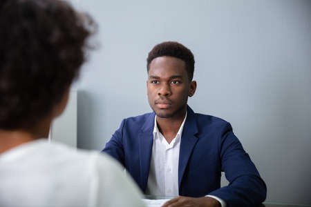 Young Businesspeople Sitting At Interview In Officeの写真素材