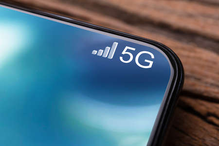 Closeups Photo Of Mobile Phone Connected To 5G Networkの写真素材