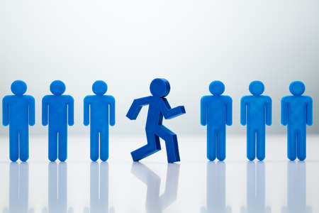 Go-Getter Running Man Standing Out From Line On Gray Backgroundの写真素材