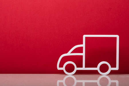 Close-up Of A Delivery Truck Symbol Leaning On Red Wallの写真素材