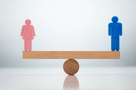 Gender Equality Concept. Male And Female Balancing On Seesawの写真素材