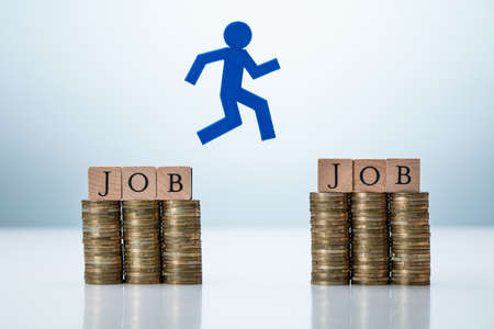 Person Jumping From One Job To Another With Slightly Higher Payの写真素材