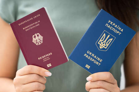 Woman Holding Two Passports. Ukrainian And German