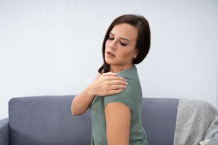 Woman Having Shoulder Pain Sitting At Home
