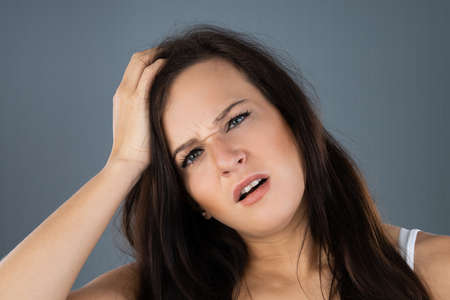 Young Woman Scratching Her Itchy Head Scalp