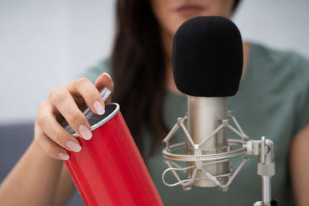 Woman Opening Can On Microphone To Make ASMR Sounds