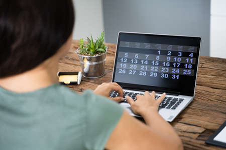 Cropped Image Of Businesswoman Using Laptop At Desk In Office