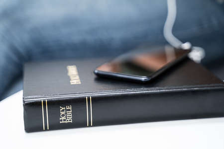 Woman Listening To Bible Audiobook On Smartphone