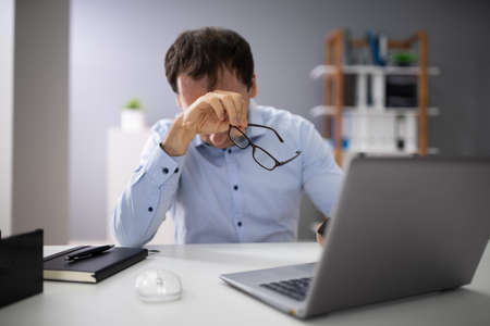 Front View Of A Stressed Businessman Sitting In Office