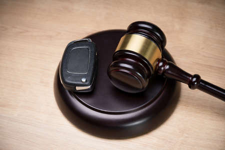 Overhead View Of A Car Key And Mallet On The Striking Block