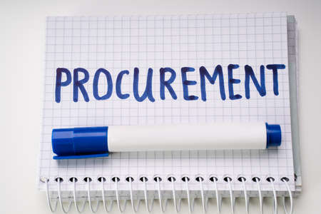 Close-up Of A Checked Notebook Showing Procurement Text And Blue Marker Over White Backgroundの写真素材