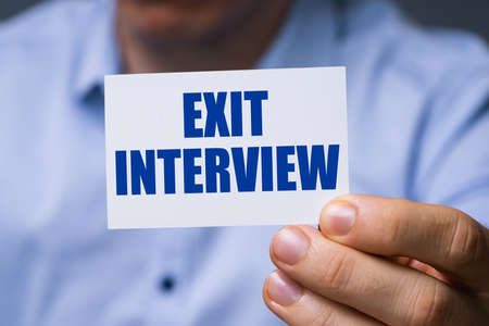 Man Showing Card With Exit Interview Text