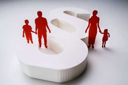Close-up Of A Red Paper Cutout Of A Separated Family With White Paragraph Signの写真素材