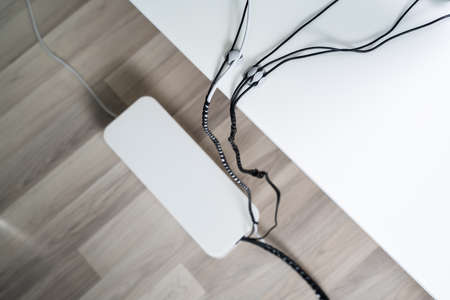Elevated View Of Compute And Laptop On Desk With Cable Organizer Box Over Hardwood Floorの写真素材