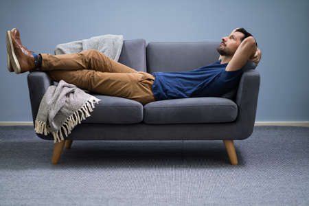 Photo Of Man Relaxing On Sofa At Home