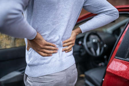 Driver Standing Having Backpain After Driving Carの写真素材