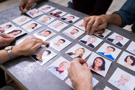 Businesspeople Hand Selecting The Candidate Portrait Photo For Hiring In Jobの写真素材