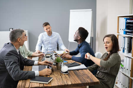 Woman Checking Time While Sitting In A Boring Long Meeting