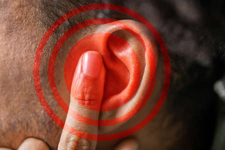 Close-up Of A Red Circle Pattern On Man's Earの写真素材