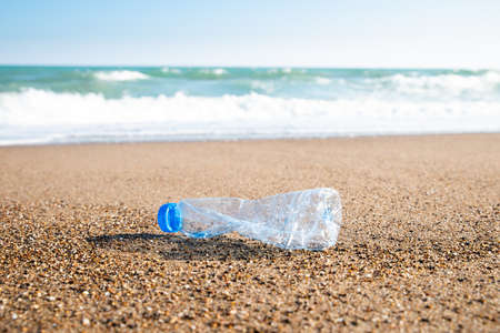 Plastic Pollution In Sea. Plastic Bottle On Sea Shoreの写真素材