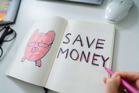 Businessperson Drawing Save Money Concept In Notepadの写真素材