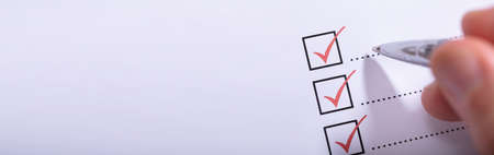 Cropped Image Of Businessman Writing On Checklist