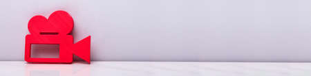 3D Video Camera Sign Leaning Against White Background