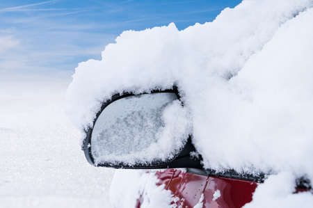 Car Mirror Covered With Snow After Snowfallの写真素材
