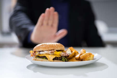 Close-up Of A Man's Hand Refusing To Eat Fest Food Burgerの写真素材