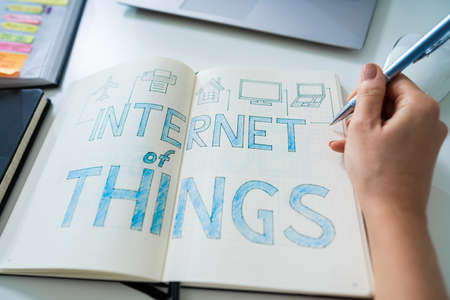 Elevated View Of A Businessperson Drawing IoT Internet Of Things Concept On Notebookの写真素材