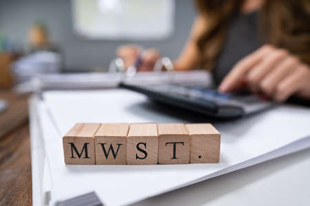 Businessperson Calculating MwSt. - Value-added tax in Germanyの写真素材