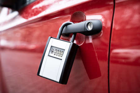 Key Safe Hanging On The Car Door With Keys Securely Stored Insideの写真素材