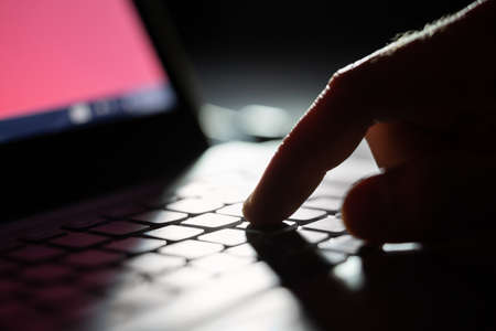 Close-up Of A Person's Hand Typing On Laptop