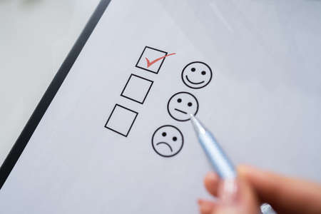 Person's Hand Ticking Off Checked Box With Penの写真素材